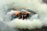Kurt Busch celebrates with a burnout after winning the NASCAR Cup Series Quaker State 400 presented by Walmart at Atlanta Motor Speedway on July 11, 2021 in Hampton, Georgia.