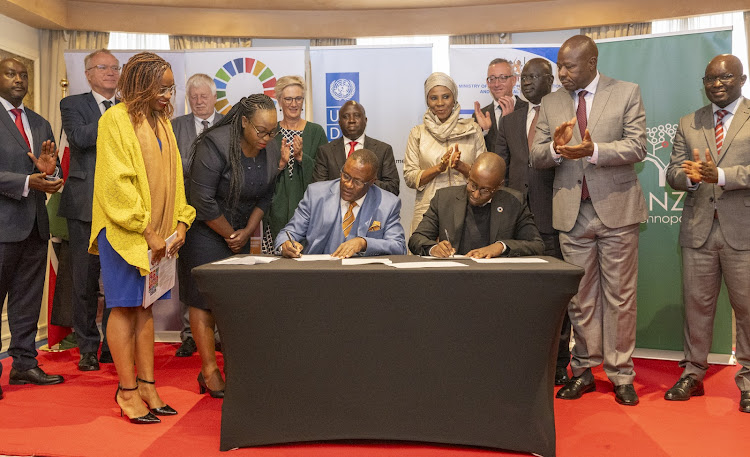 ICT CS Eliud Owalo and UNDP Kenya resident representative Anthony Ngororano sign the MOU that seeks to accelerate the country's digital transformation to bridge the existing divide.