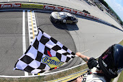 Tyler Reddick takes the checkered flag to win the NASCAR Cup Series Kwik Trip 250 at Road America on July 3 2022 in Elkhart Lake, Wisconsin.