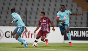 Thabang Monare (left) and Ntsikelelo Nyauza of Orlando Pirates challenge Keletso Makgalwa of Swallows FC in the DStv Premiership match at Dobsonville Stadium in Johannesburg on December 14 2021.