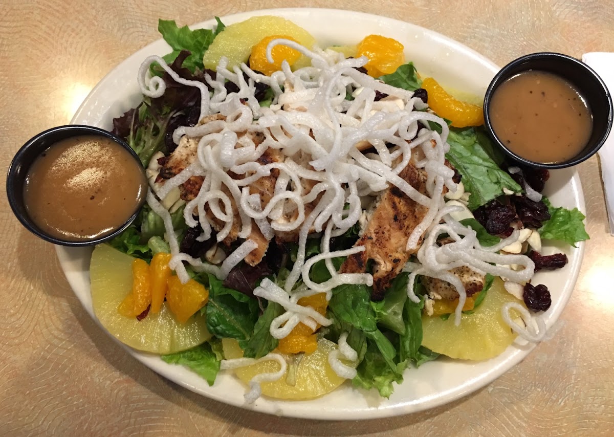 Oriental Chicken Salad. Chicken, oranges, pineapple, almonds, Craisins, rice noodles with housemade Oriental dressing.