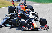 Max Verstappen in the Red Bull ends up on top of Lewis Hamilton's Mercedes during the 2021 Italian Grand Prix at Monza.
