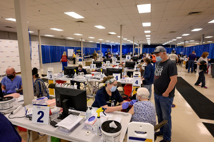 A healthcare worker administers the Pfizer Covid-19 vaccination to a resident at a West Virginia United Health System vaccine clinic in Morgantown, West Virginia, US, in this March 11 2021 file photo. Picture: BLOOMBERG/JUSTIN MERRIMAN