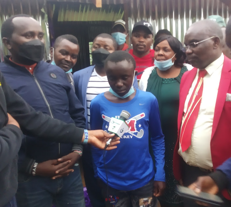 Brian Maina, 16, with the well-wishers at his grandmother's home in Kiritu, Kigumo on Saturday.