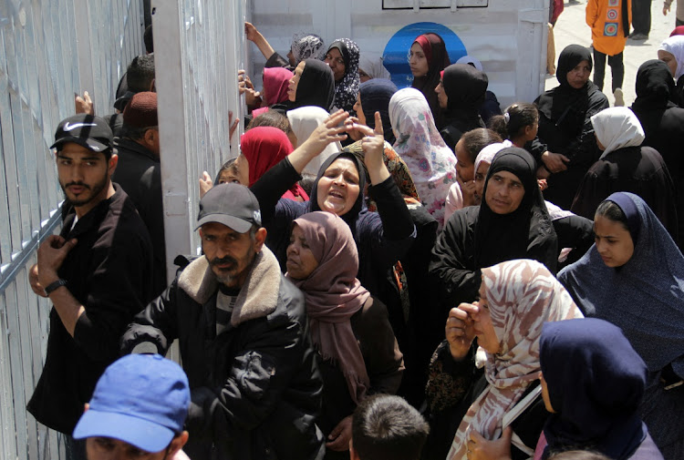 Palestinians gather to buy bread from a bakery in Gaza City, April 14 2024. Picture: REUTERS/Mahmoud Issa