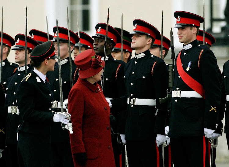 Queen Elizabeth looks up at a smiling Prince William during the Sovereign's Parade at the Royal Military Academy in Sandhurst, southern England, Britain, December 15, 2006. Picture: REUTERS/Dylan Martinez