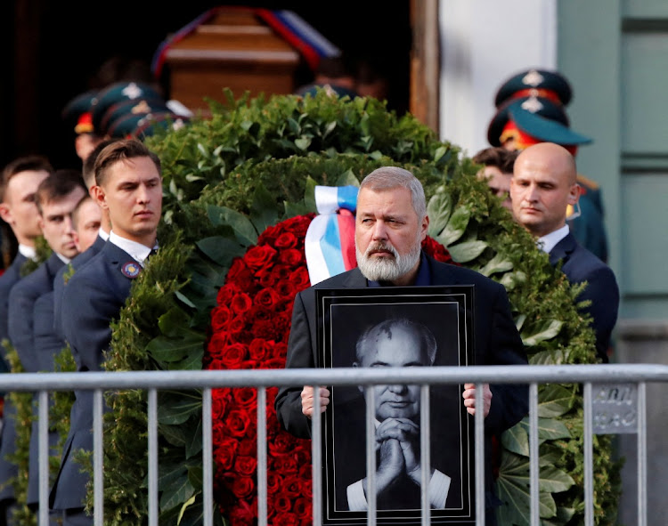 Dmitry Muratov, the co-winner of the 2021 Nobel peace prize, carries a portrait of the late Mikhail Gorbachev, the last leader of the Soviet Union, in Moscow, Russia, September 3 2022. Picture: SHAMIL ZHUMATOV/REUTERS