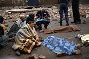 Relatives mourn the loss of young children, after a wall collapsed onto them while they were playing, in Doornfontein, Johannesburg.