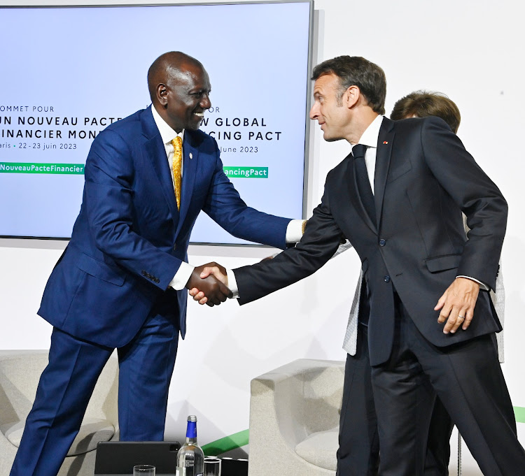 President William Ruto greeting dignitary during a roundtable meeting in Paris on June 22.