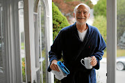 GREY EMINENCE Michael Rosbash, a professor at Brandeis University near Boston in the US, retrieves the  morning newspaper on Monday at his home in Newton, Massachusetts, after learning he is one of the 2017 Nobel prize for medicine winners Picture: Brian Snyder/Reuters