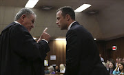 Advocate Barry Roux with Oscar Pistorius at the Pretoria High Court on March 5, 2014, in Pretoria, South Africa. Oscar Pistorius, stands accused of the murder of his girlfriend, Reeva Steenkamp, on February 14, 2014. This is Pistorius' official trial, the result of which will determine the paralympian athlete's fate. (Photo by Alon Skuy/The Times/Gallo Images - Pool/Getty Images)