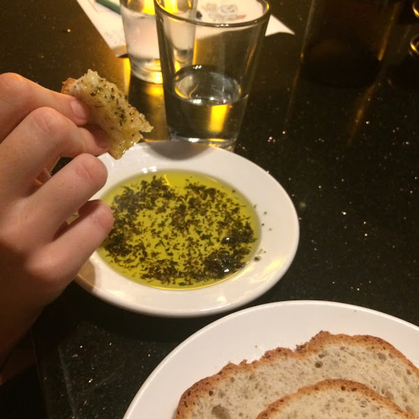 Separate plate of olive oil and herbs for dipping the warm GF bread as an appetizer.