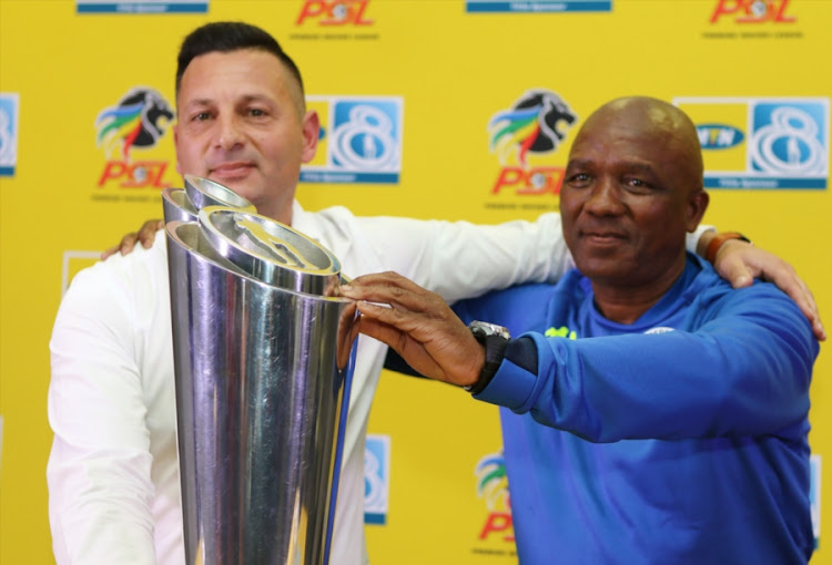 Cape Town City assistant coach Vasili Manousakis (L) pose for photographs with the MTN8 trophy with his SuperSport United counterpart Godfrey Mosoetsa ahead of the final at the Moses Mabhida Stadium in Durban on Saturday September 29 2018.