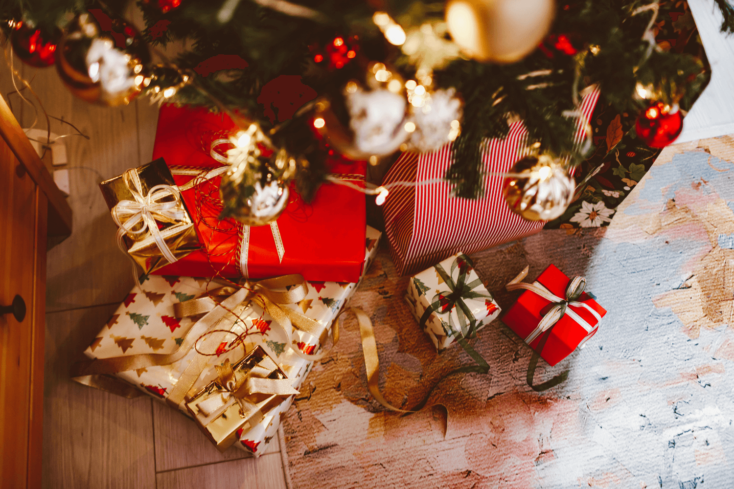 Multicolored wrapped gifts under a christmas tree