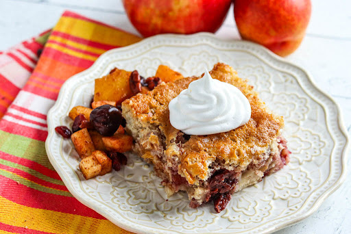 Deep Summer Fruit Cobbler with a dollop of whipped cream.