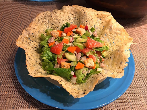 A cheese bowl with salad on a blue plate.