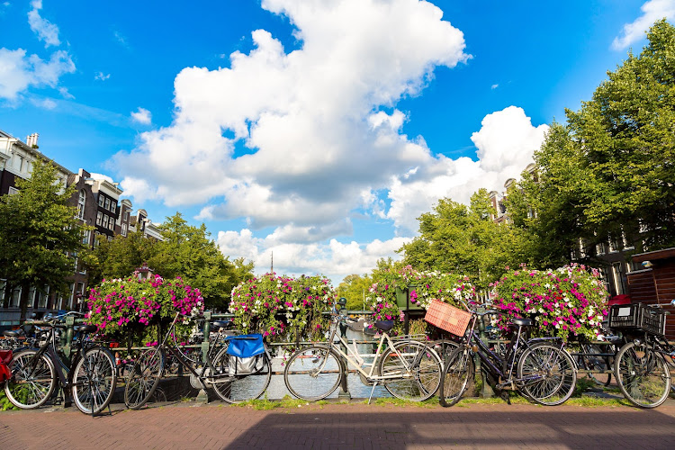 Bicycles on a bridge over a canal in Amsterdam.