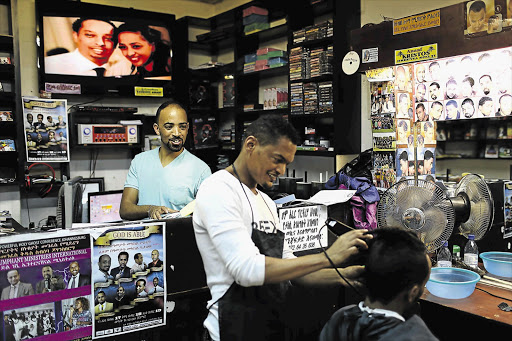 ETHIOPIAN-STYLE: It's not your average barber shop, but then it is situated in an enclave in Johannesburg that seems a long way from South Africa: Little Addis, where members of Joburg's Ethiopian community meet, eat, mingle, buy, sell, barter and get their hair cut.