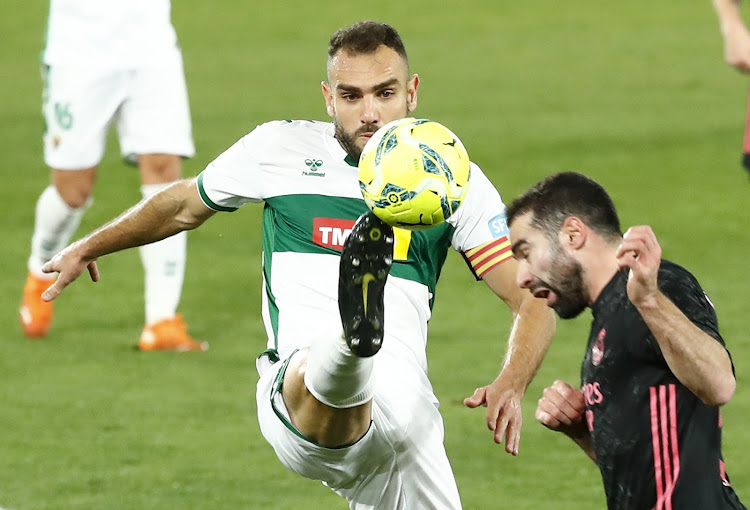 Elche's Gonzalo Verdu in action with Real Madrid's Dani Carvajal