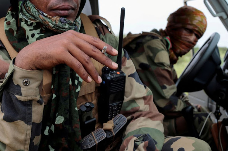 A Malian officer waits in a pickup truck during a patrol with soldiers from the new Takuba force near Niger border in Dansongo Circle, Mali August 23, 2021