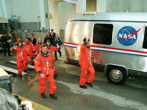 The STS-99 crew wave to onlookers they are foreground Pilot Dominic Gorie and Kevin Kregel.