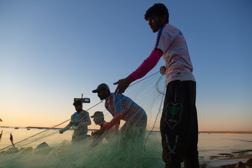 Local fishermen preparing the fishing net for the overnight fishing