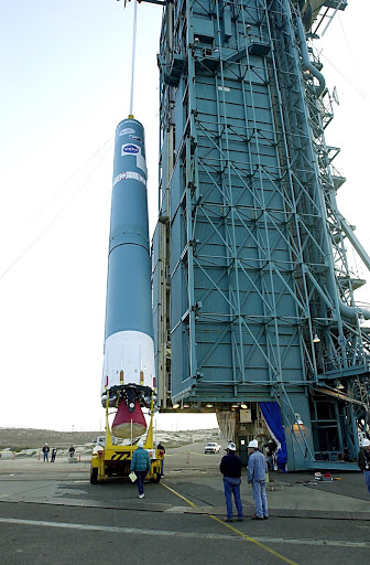 The first stage of the Delta II rocket is raised to a vertical position at NASA's Space Launch Complex 2 SLC 2.