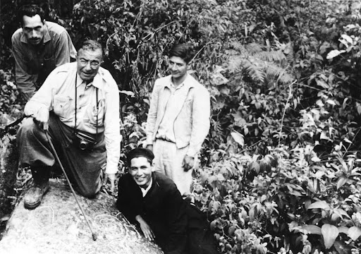 Dr. Hans Feriz and others posing with rock drawings