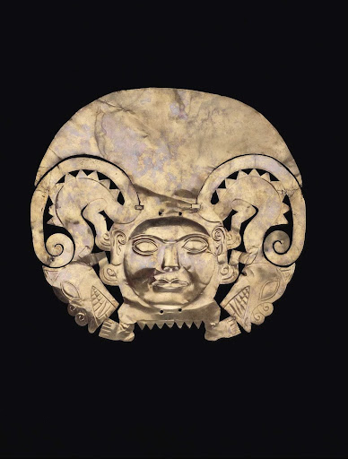 Gold headdress that represents a human face flanked by rampant felines ML100769