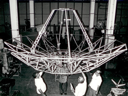 Ooty Radio Telescope - indoors persons gathered around machinery