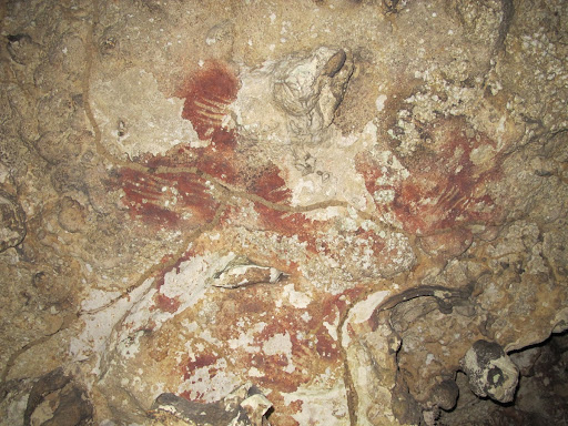 A Panel of narrowed fingers at ceiling of Lompoa Cave
