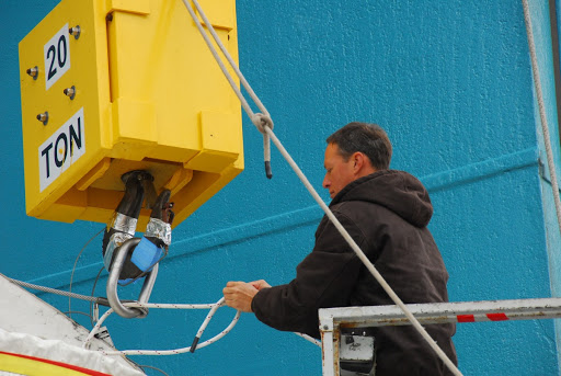 A spacecraft technician secures the interstage of the United Launch Alliance Delta II Operational Environmental Satellite System Preparatory Project.