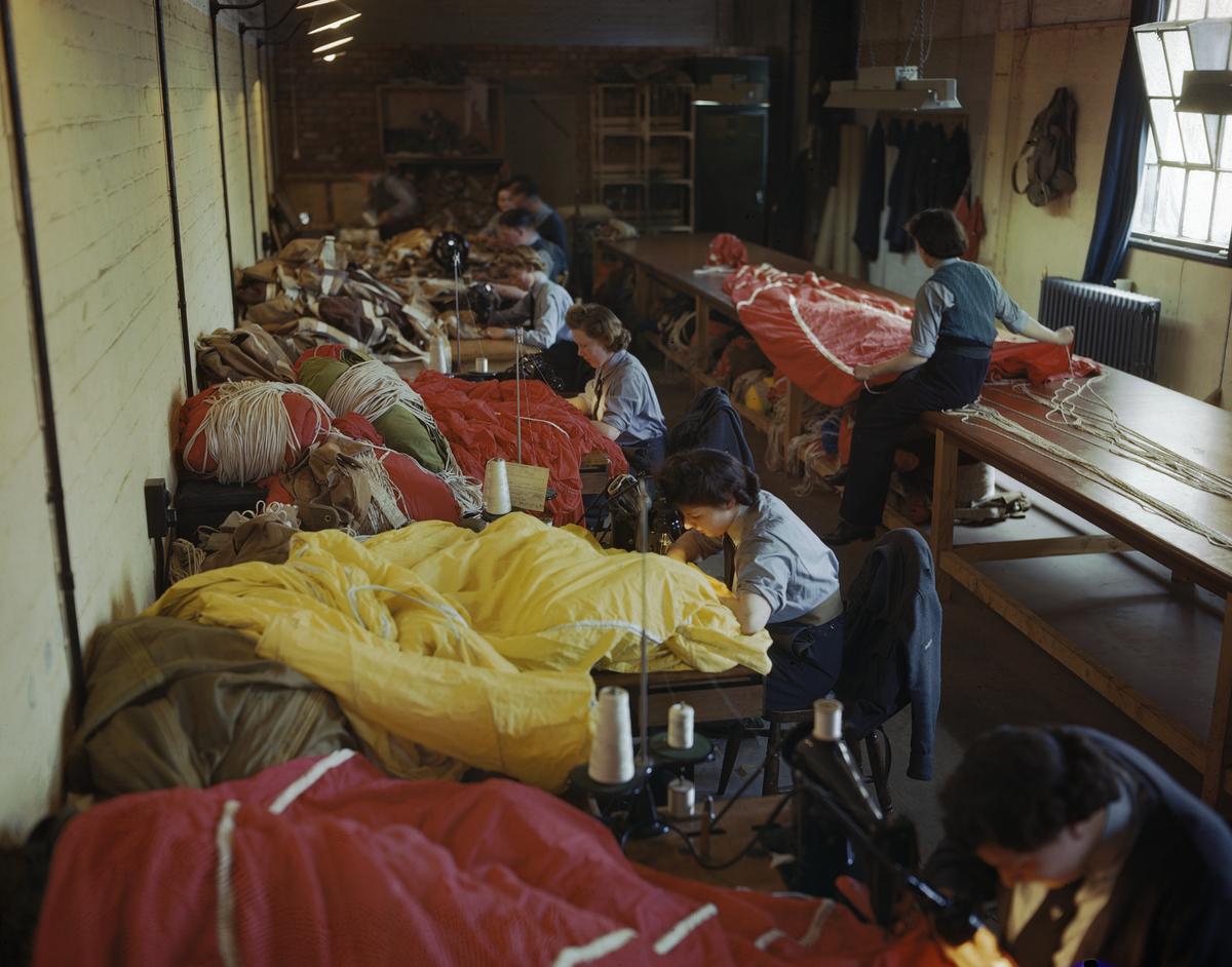 Members of the Women’s Auxiliary Air Force (WAAF) repair and pack parachutes for use by airborne troops during the Normandy invasion, 31 May 1944
