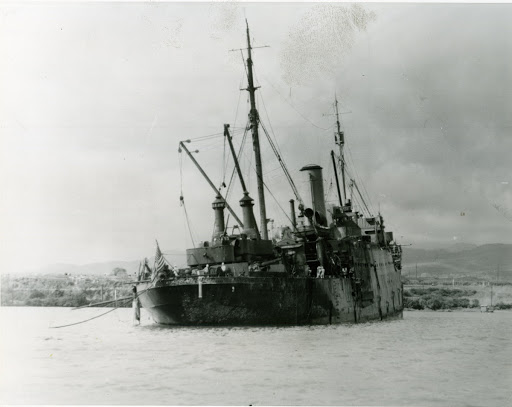 View taken at Pearl Harbor after the Japanese attack on 7 December 1941. The ship had been damaged and was beach off area landing. Note scorched paintwork aft, where she was effected by the burning oil of USS Arizona BB-39.