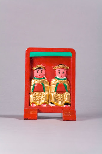 A red tablet of a pair made in a convex form with stands