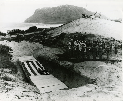 Firing volleys over bodies of fifteen officer and men who perished in attack on Kaneohe by Japanese.