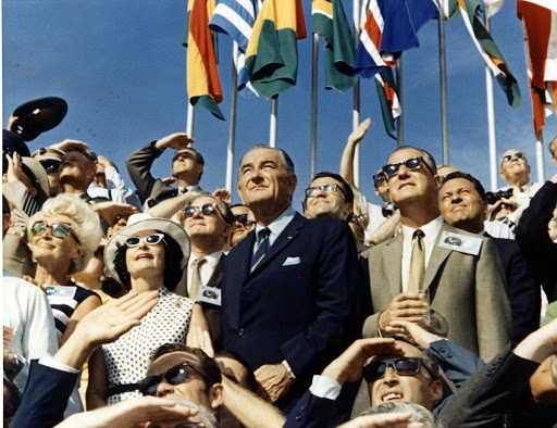 Spiro Agnew and Lyndon Johnson view the liftoff of Apollo 11 from the stands located at the Kennedy Space Center VIP viewing site.