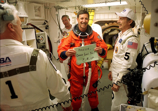 STS Commander Scott Horowitz sends a message home while preparing to enter Space Shuttle Discovery for launch.
