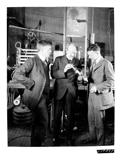 Irving Langmuir, Sir J.J. Thomson, and William Coolidge examine an electron tube developed at the GE Research Laboratory during one of Thomson's visits to Schenectady.