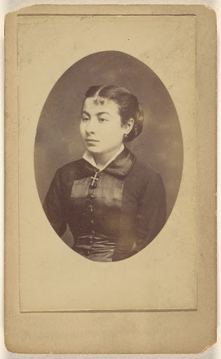 [Unidentified young woman wearing a crucifix around her neck] (Verso)