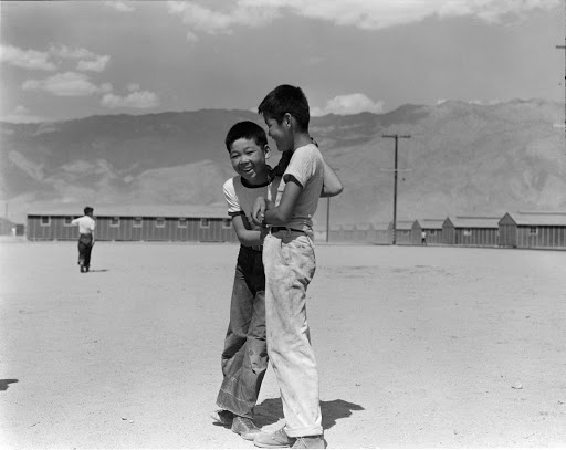 Boys on a windswept field at the Manzanar Relocation Center.