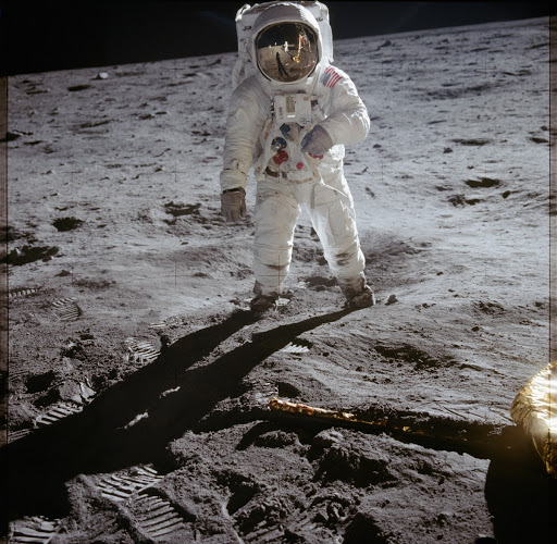 Astronaut Edwin Aldrin walks on lunar surface near leg of Lunar Module
