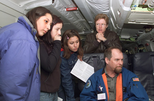 JPL scientist Dr. David Imel and U.S. Air Force Colonel Gwen Linde lead Chilean students on a tour of the DC-8 aircraft in Punta Arenas, Chile