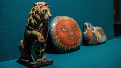 lion sculpture and river rocks painted by Marsi