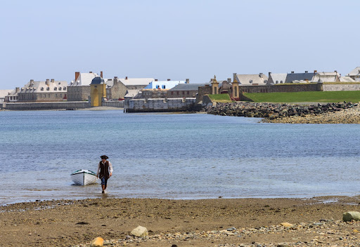 Costumed interpreter brings in a boat to shore at the Fortress of Louisbourg
