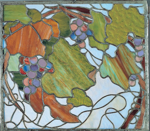 Glass with grape bunches and leaves