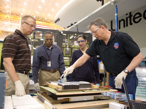 STS-133 crew members Drew, Kopra and Stott during EVA Tile Repair.