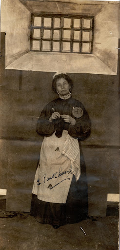 Emmeline Pankhurst in prison uniform, knitting