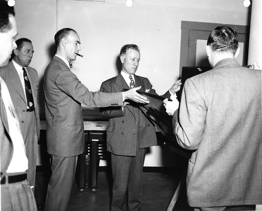 Plans of the General Electric Company's expanding turbojet and turbo-prop center at Lockland Ohio, are checked by Ralph J. Cordiner (center) company president, during a visit to the plant April 26 1951. At his right is K. F. Houseman, plant manager.