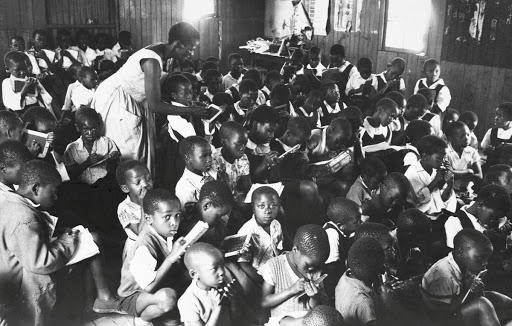 Teacher above is struggling with one of her two daily sessions of 100 students each - Photographs from House of Bondage, 1958-66